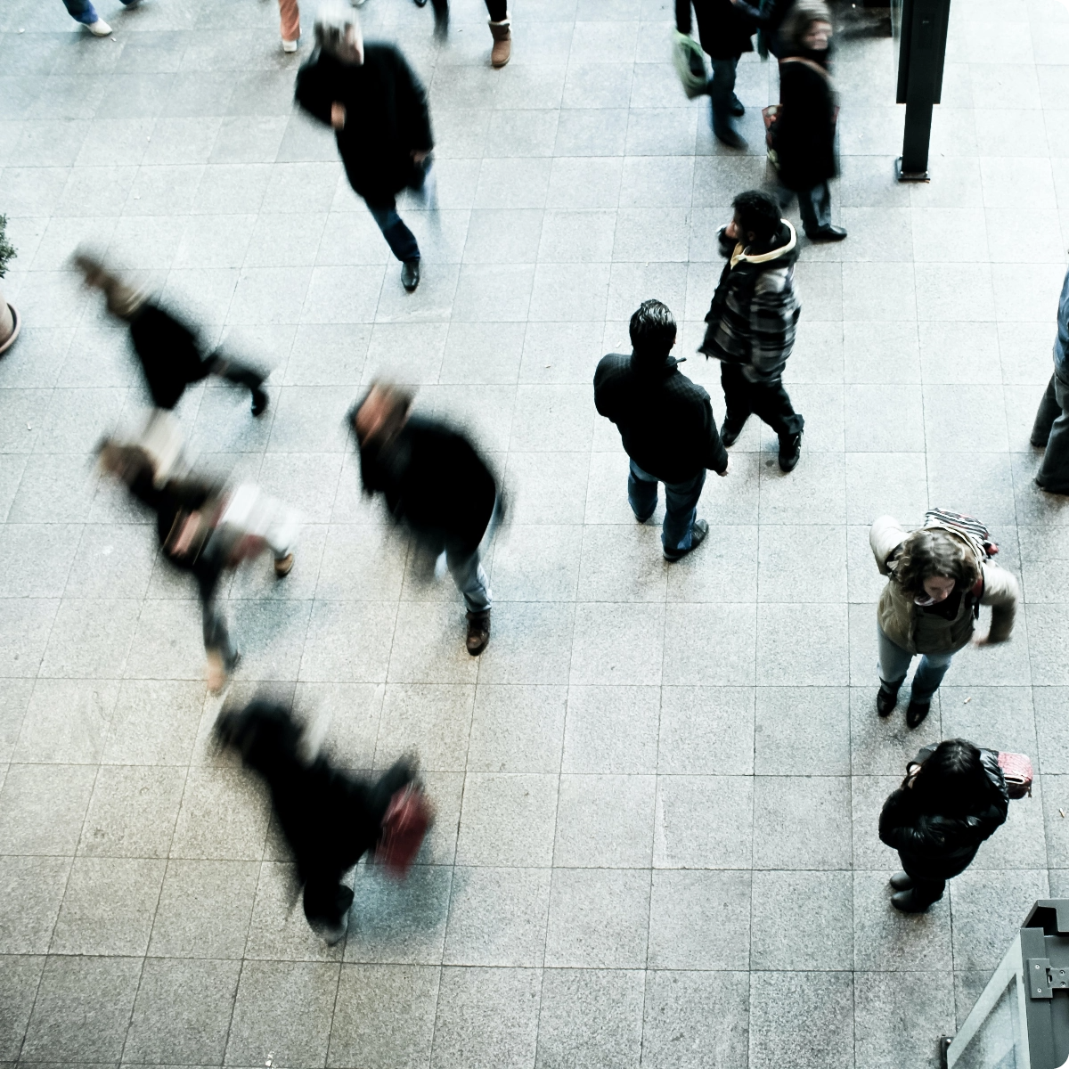 people moving through a busy courtyard